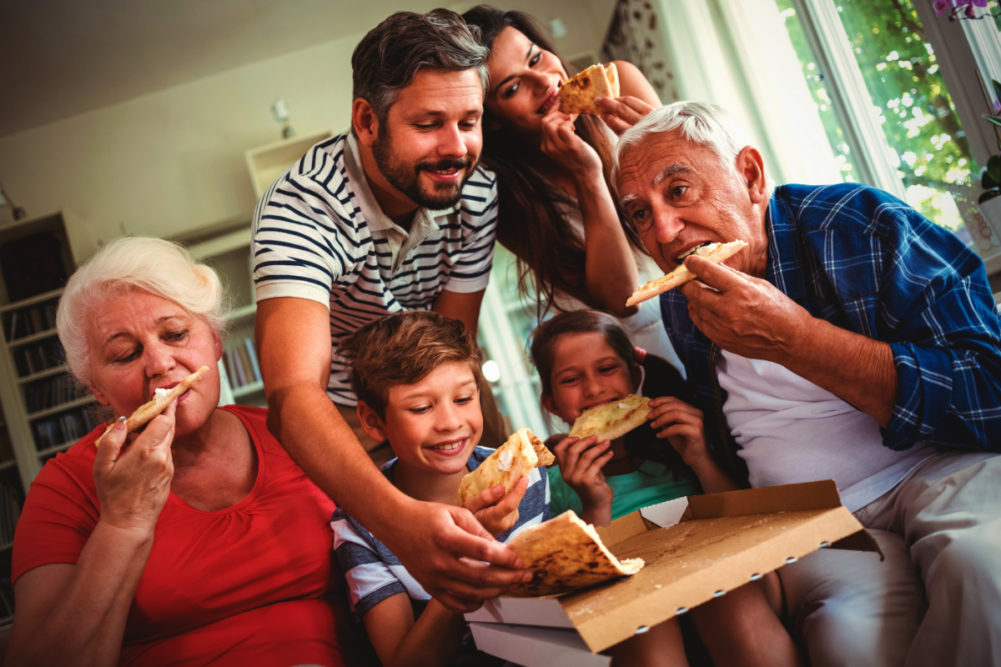 Different generations eating pizza