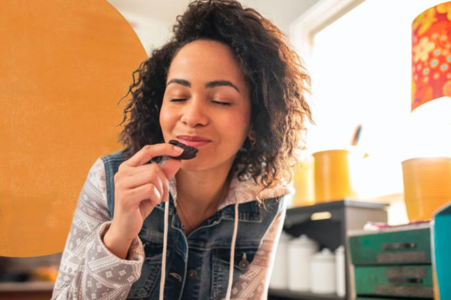 Young woman snacking on Oreos