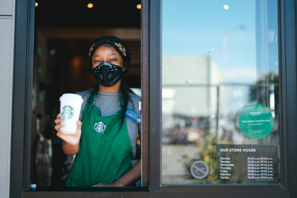 Starbucks drive-thru worker wearing mask for COVID-19