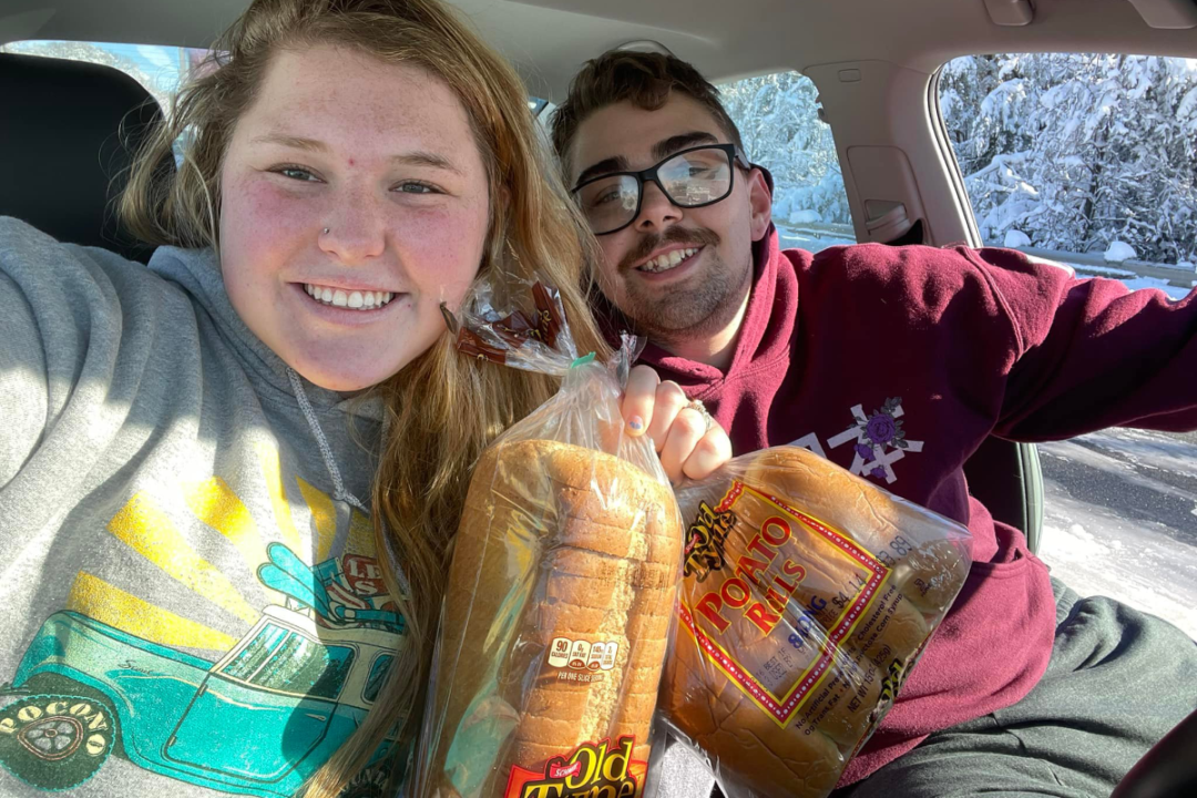 Casey Holihan and John Noe with their loaves of Old Tyme wheat bread and Old Tyme potato rolls