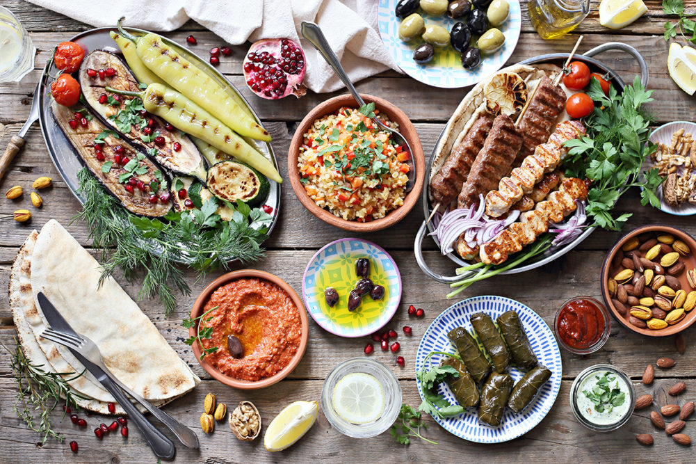 spread of Mediterranean foods on a wooden table